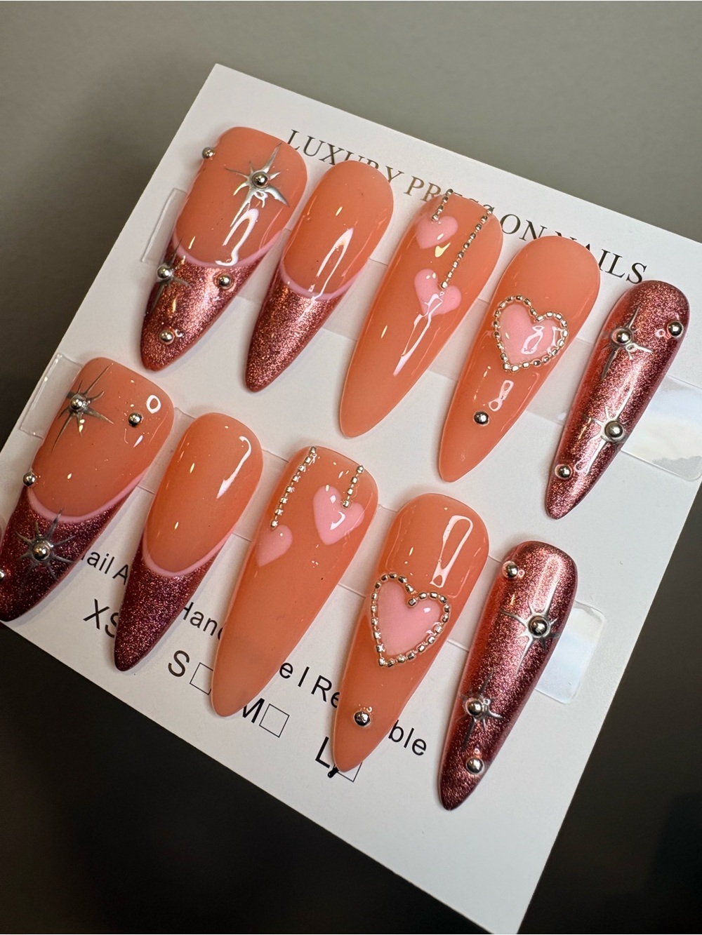 Peach Glam Stiletto Press-On Nails with Pink Hearts & Rose Metallic Tips
